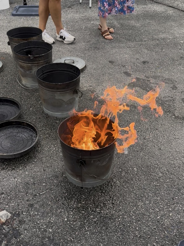 Flames rising from a reduction chamber during a live Raku pottery firing at House of Clay